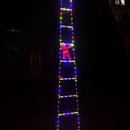 Holiday home entrance decorated with Santa and LED ladder.